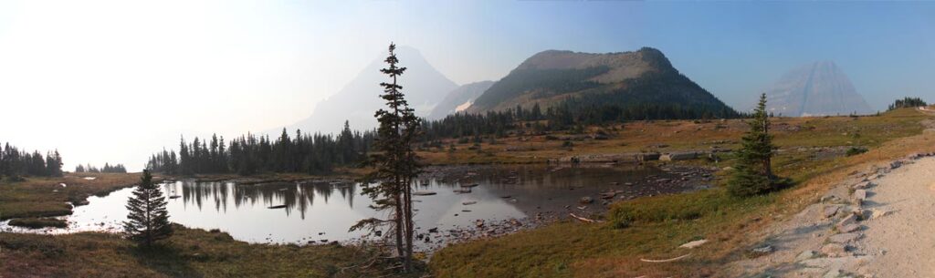 lake surrounded by misty mountains