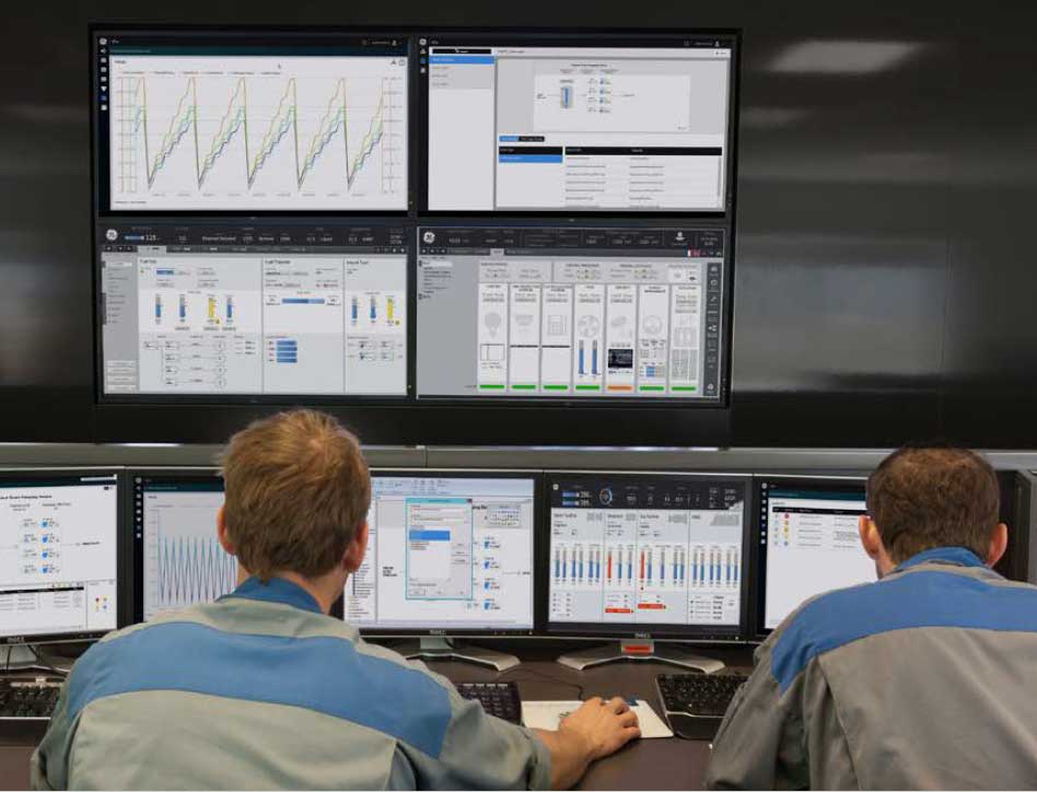 two engineers reviewing screens of a power plant